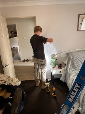 EWJ Electrical apprentice running wiring in a Brisbane bedroom renovation