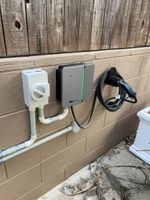 Completed EV charger installation on an external brick wall by EWJ Electrical, Brisbane