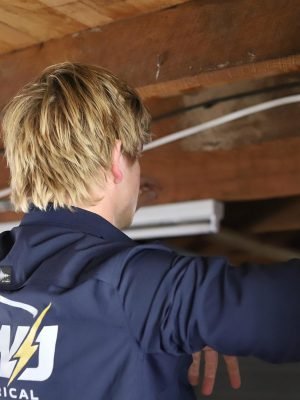 EWJ Electrical electrician running new cable through a garage ceiling in Brisbane