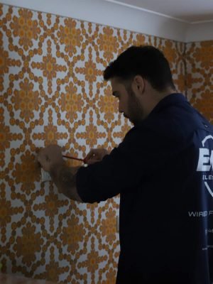EWJ Electrical electrician marking out a new power point on a wall in a Brisbane home