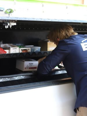 EWJ Electrical electrician collecting parts from the ute toolbox on a Brisbane job
